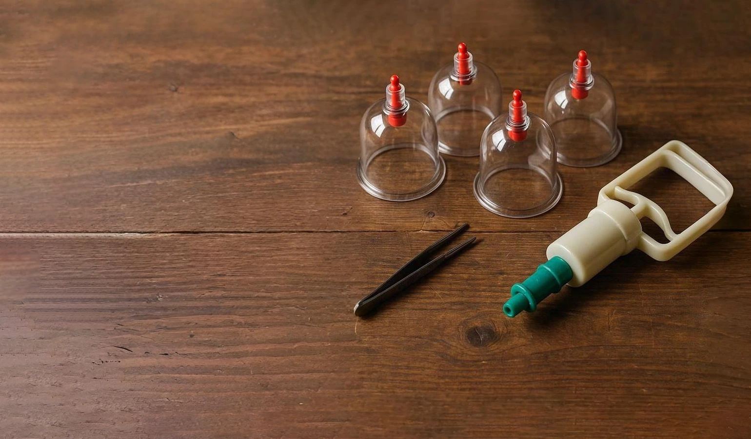 Traditional Hijamah cupping set with glass cups on a wooden table